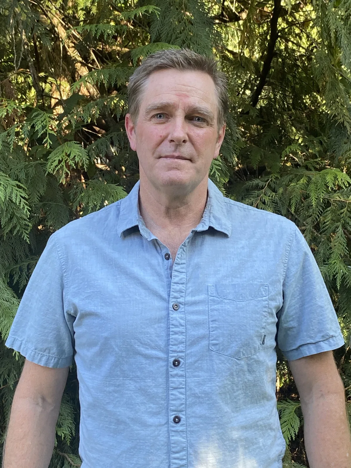 Jeff Metcalfe standing outdoors in a blue shirt