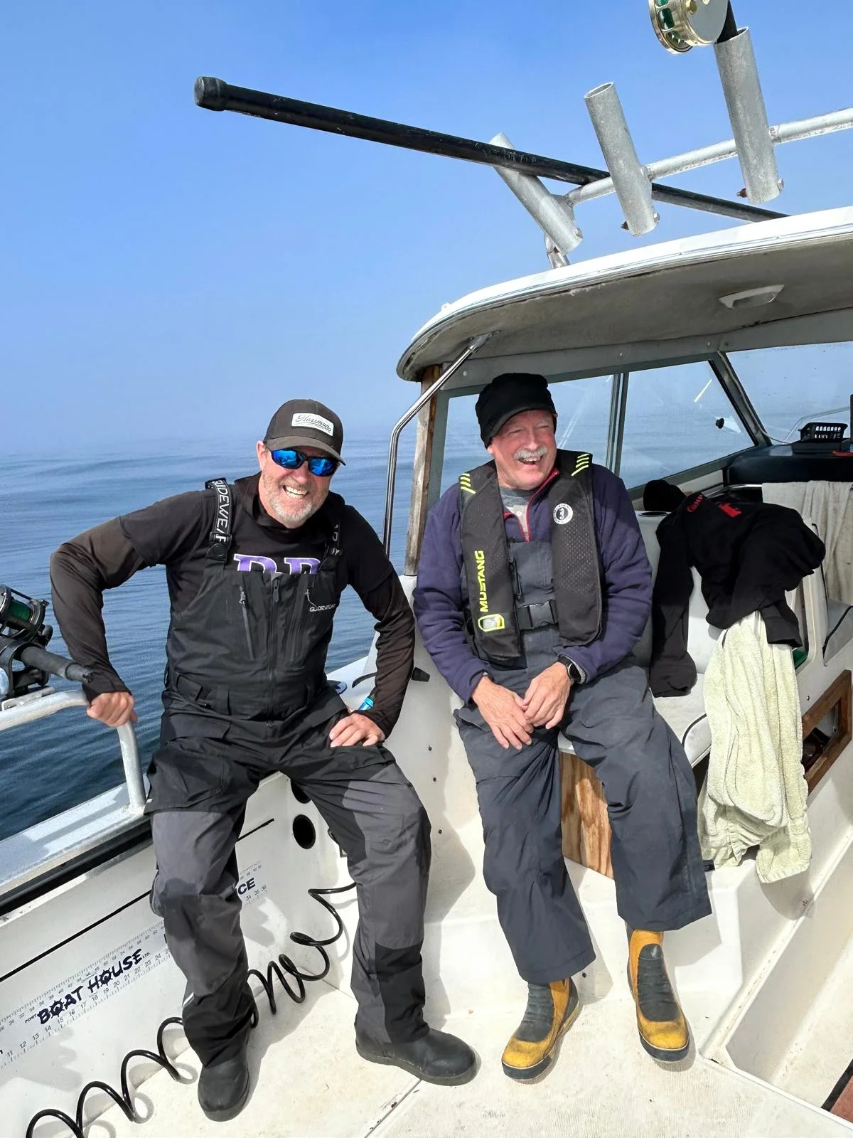 Jeff and a companion smiling aboard a fishing boat